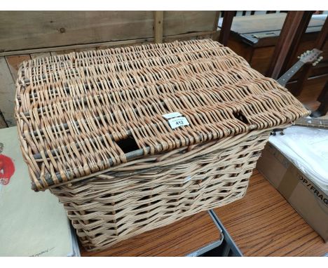 A Wicker basket containing tapestry pictures 