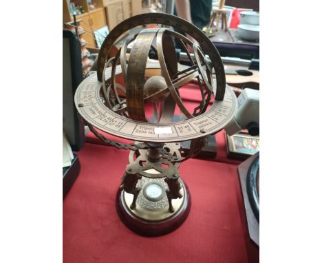 An Antique Brass Armillary Nautical globe with fitted compass 