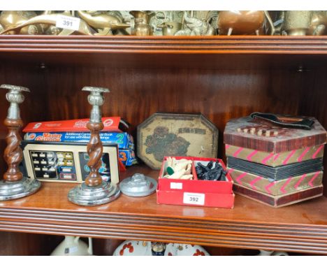 A Shelf of collectables includes musical squeeze box chess pieces and other items 