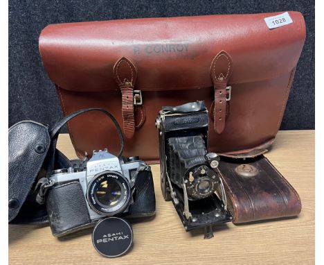Vintage brown satchel bag together with two various camera; Voigtlander bellow camera with case and Asahi Pentax camera with 