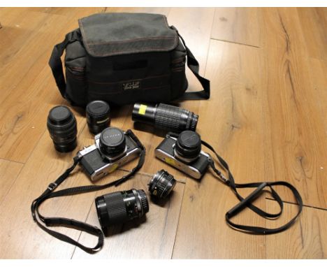 Pentax ME Super with 50 mm lens, Pentax Model K1000 with 50 mm lens and camera bag containing lenses, Ryka, Pentax and Takuma