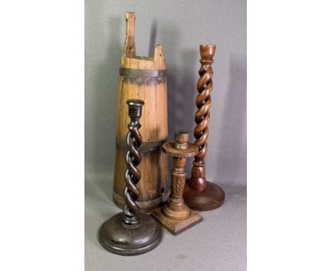 TREEN - twist candlesticks, 32cms the tallest, another carved candlestick and a conical shaped banded wooden barrel with hand