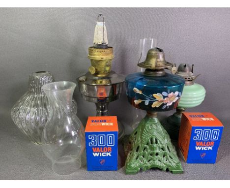 IRON BASED OIL LAMP - with floral painted blue glass reservoir, two other oil lamps, shades, wicks, ETC