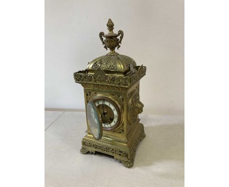 Mid 19th century French decoratively, cast ormulu cased mantel clock, enamel chapter ring with Roman numerals. Hour and half 