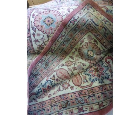 A Large Middle Eastern Pink and Beige Carpet. 