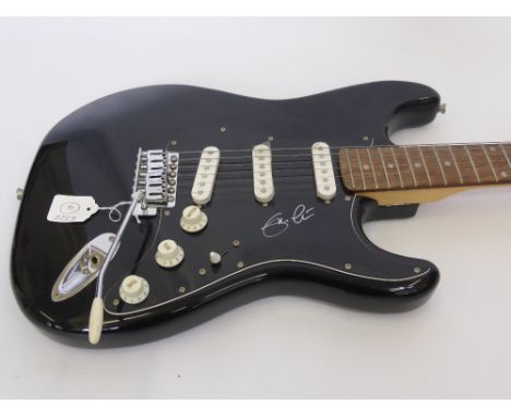 A Black Fender "Squier" Guitar signed by Eric Clapton.