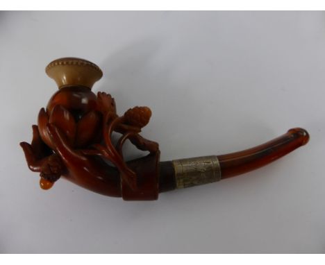 An Antique Amber Meerschaum Pipe, the pipe in the form of a hand clasping a lotus flower, in original box. 