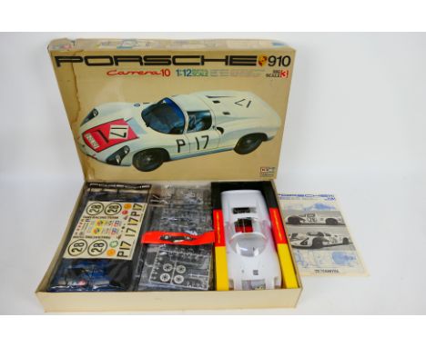 Tamiya - A boxed unmade Porsche Carrera 10 model kit in 1:12 scale # BS1203. Released in 1968. The contents appear Mint with 