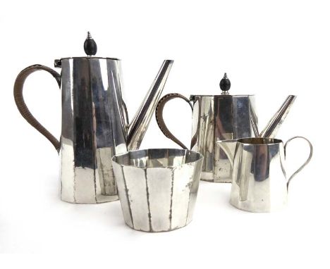 An Edwardian silver four piece bachelor's tea service of canted slender tapered form in the manner of Christopher Dresser, He