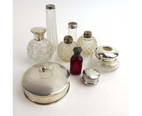 A silver and engine turned dressing table box of circular form, d. 10.5 cm, a silver mounted ruby glass scent bottle, a small