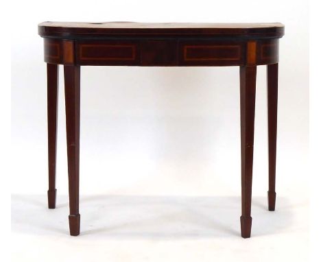 A Georgian walnut, satinwood and crossbanded card table, the folding surface over an inlaid frieze on square tapering legs wi