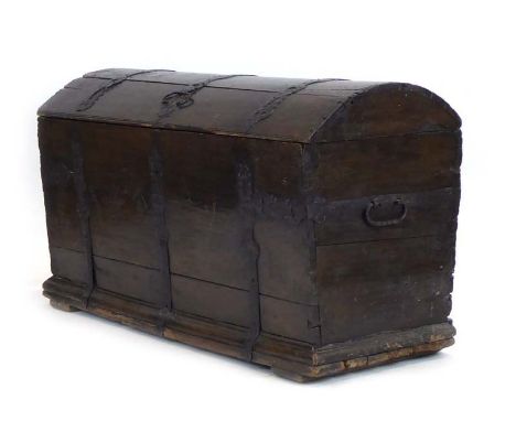 An 18th century and later oak and iron bound dome topped trunk, l. 134 cm