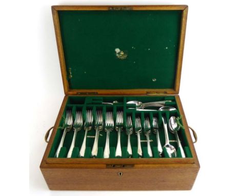 An oak canteen containing a suite of Georgian and later old English pattern brightcut engraved silver flatware comprising:18 