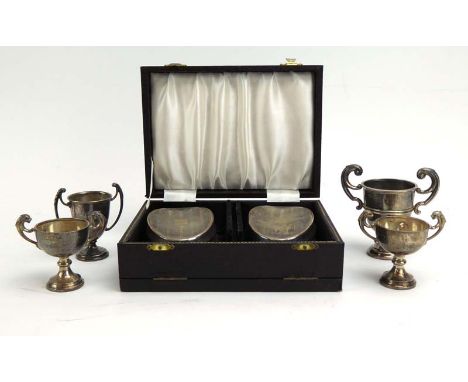 A cased pair of silver engine turned brushes of oval form, together with four miniature silver trophy vases, various dates an