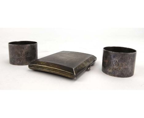 A silver engine turned cigarette case of rectangular form, JC Ltd., Birmingham 1929, l. 8.5 cm, together with a pair of plain