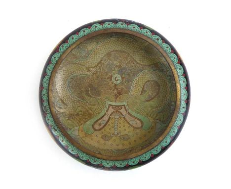 A Chinese cloisonne enamel dish of circular form, typically decorated with dragons within a famille noir ground, d. 24.5 cm C