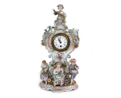 A late 19th/early 20th century mantel timepiece within a Dresden florally encrusted figural case, h. 38.5 cm CONDITION REPORT