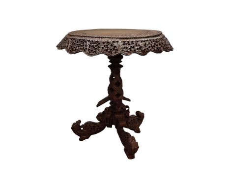 Burmese hardwood tripod table, circular top and pieced frieze decorated with animals and foliage on entwined support with thr