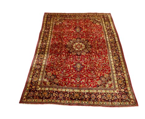 Large Persian Kashan red ground rug carpet, blue ground central medallion with floral motifs repeated in border, interlacing 