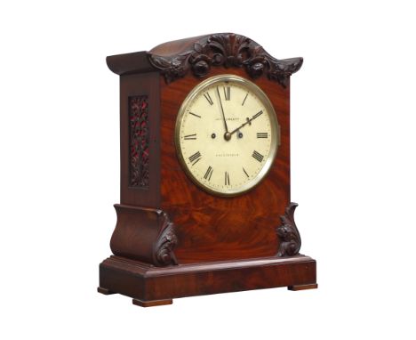 Victorian mahogany mantel clock, serpentine pediment with carved floral mounts, circular painted dial signed 'JNo, Howlett, C