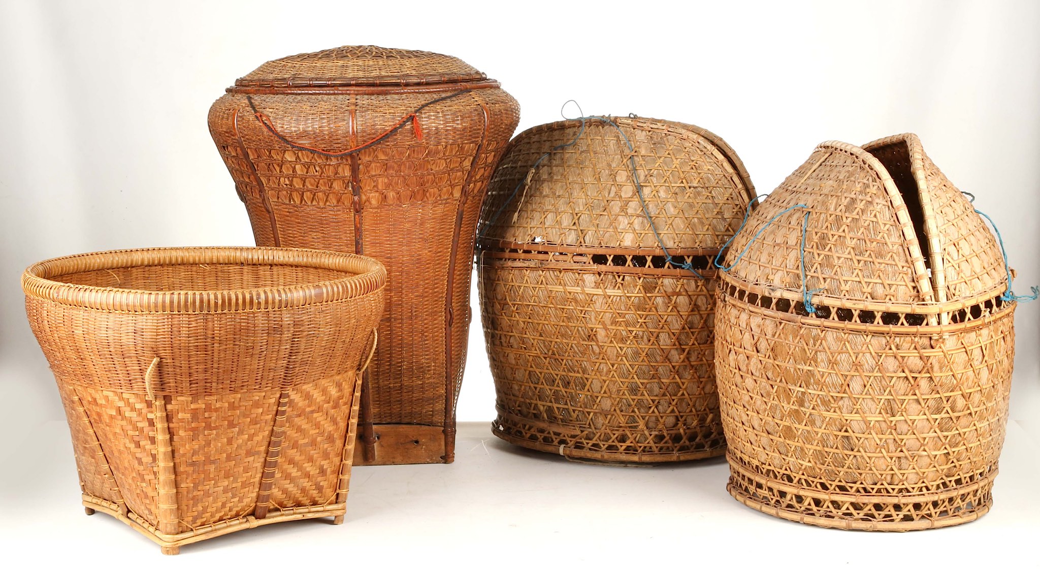 FOUR BAMBOO BASKETS, INDONESIA Including a burden basket with lid and