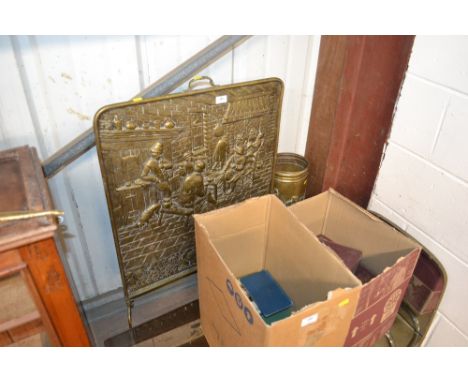 A large brass embossed fire screen; and a brass embossed stick stand 