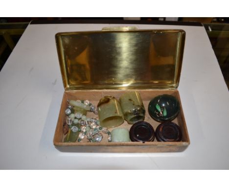 A brass box of various jade items to include small bowls and cups 