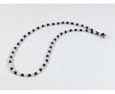 LAPIS & PEARL. A lapis lazuli & river pearl necklace with 9ct. gold clasp. Length 43cm.  Please note that all items in this a