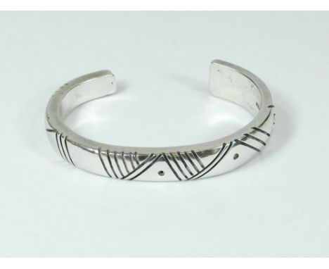 NAVAJO SILVER. A Navajo silver bangle, hand made by Jimmie King Jnr. Fully stamped Navajo, Sterling & with facsimile signatur