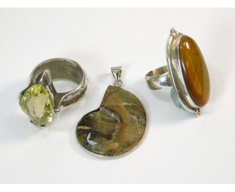 SILVER RINGS ETC. A large silver & tiger's eye dress ring & one other substantial silver dress ring, set a faceted yellow sto