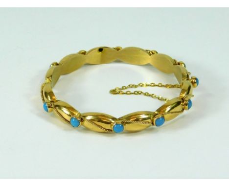 TURQUOISE BANGLE. A hinged yellow metal bangle set with turquoise & applied rope twist decoration. Stamped with apparently Mi