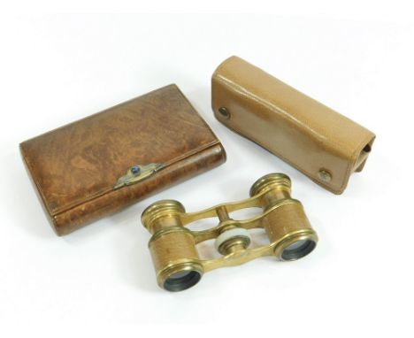 CIGARETTE CASE ETC. A leather covered cigarette case with jewelled gilt metal thumb-piece. The interior with a section for ma