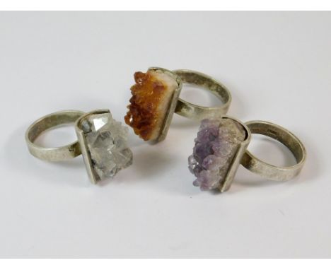 MAGNUS MAXIMUS DESIGNS. Three Magnus Maximus Designs of Frizington, Cumbria, silver rings, all with curved settings, includin