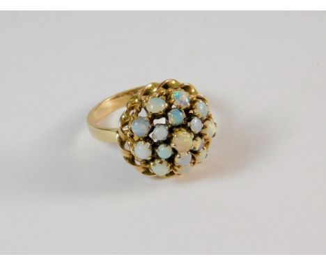 OPAL RING. An opal cluster ring set and mounted in unstamped yellow metal. Size J.  Please note that all items in this auctio