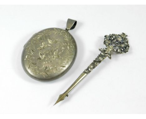 LOCKET ETC. An early 20th century large, engraved silver locket, length incl. bale 7.2cm. Also, a 19th century paste set cloa