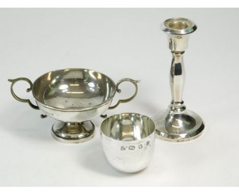 CANDLESTICK ETC. An early 1920's silver candlestick, 13cm. Also, a modern silver beaker by Wakely & Wheeler & a twin-handled 