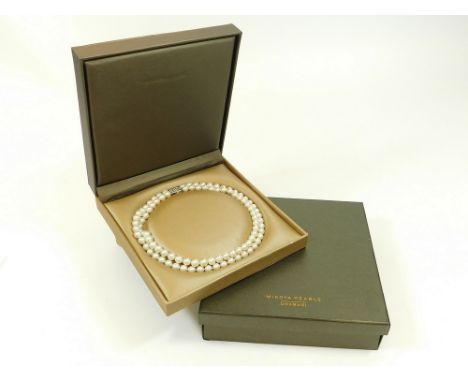 MIKOYA PEARLS. A double strand of Mikoya cultured pearls, with 18k. white gold clasp, set with 26 brilliant cut diamonds. Ret