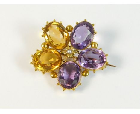 PANSY BROOCH. A Victorian pansy brooch set with three oval amethyst & two oval citrine, at the centre a split pearl. The whol