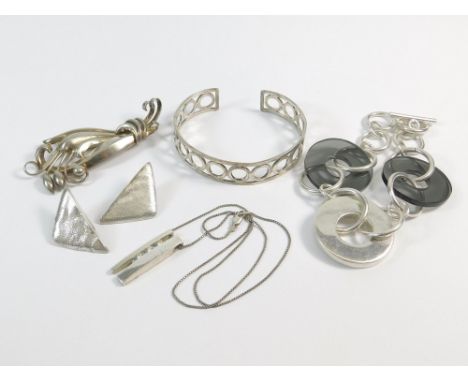 SILVER BRACELETS ETC. A hand made silver & acrylic bracelet by Tego & Co. Also, a silver open work bangle, a pair of cast tri