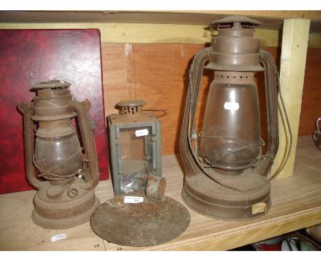 Two Tilly lamps (one is a Tornado), glass lantern and a metal candle stick