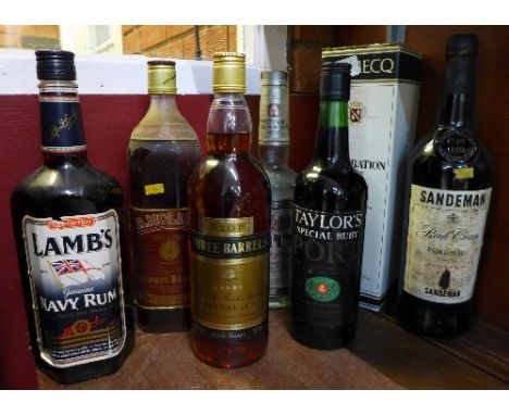 Seven bottles of spirits, including Sandeman Sherry, Taylors Special Ruby Port, Domecq Sherry, Lamb's Navy Rum, etc.