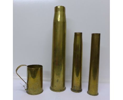 Three brass shell cases and a brass trench art mug