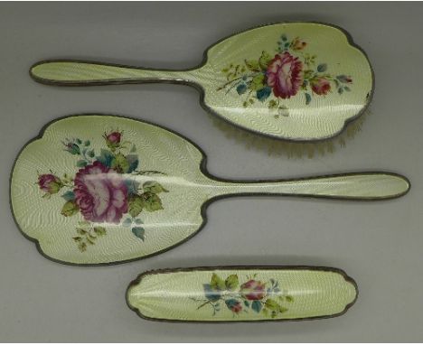 An enamel brush set made by Adie Bros.