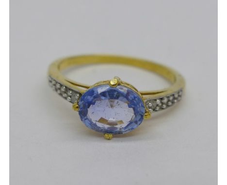 A silver gilt ring set with sapphire and ten diamonds, R