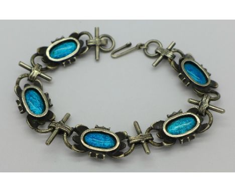 A white metal and enamel bracelet