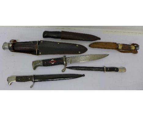 A German dagger, no scabbard, three other daggers with scabbards and two paper knives in the form of small bayonets