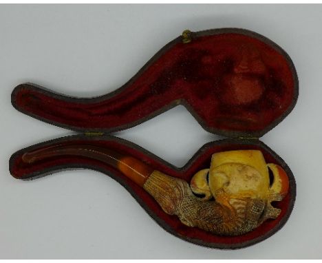 A cased ivory Meerschaum pipe with amber stem