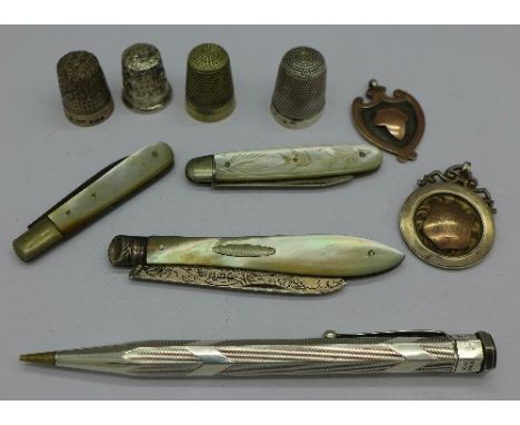 Three silver thimbles, one other thimble, a silver Yard-O-Led pencil, three silver and mother of pearl fruit knives and two s