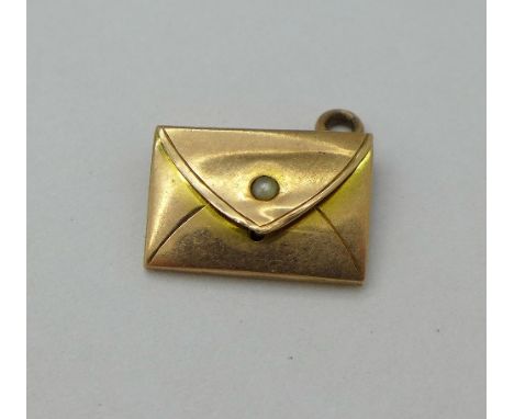 A yellow metal envelope charm set with a pearl, 1g, tests as gold