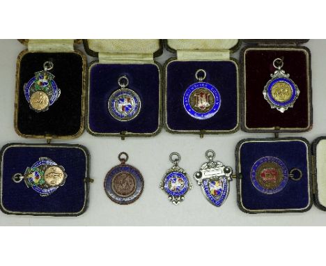 A collection of seven silver and enamel and two other fob medals including gold decorated, 1930's, Birmingham area cricket an